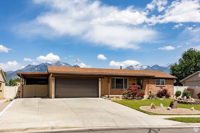 8097 S 535 E, Sandy, UT 84070 - single story home featuring a mountain view, an attached garage, brick siding, and concrete driveway