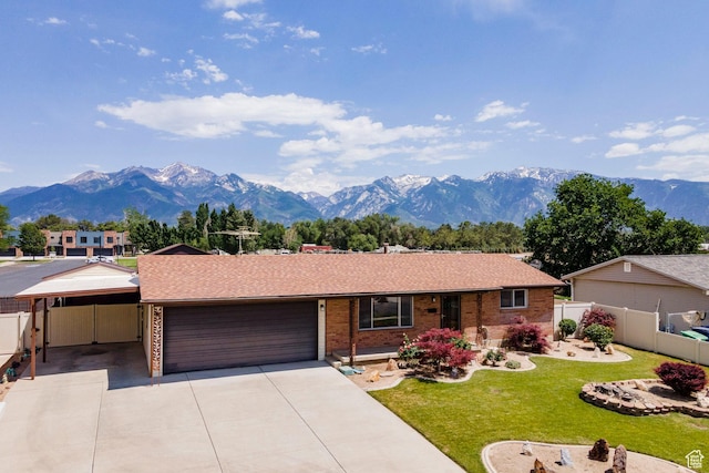 8097 S 535 E, Sandy, UT 84070 - single story home featuring a mountain view, an attached garage, driveway, a carport, and brick siding