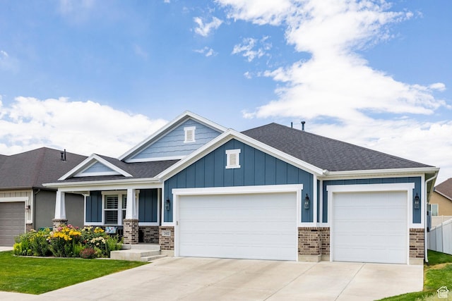 2402 W 525 S, Layton, UT 84041 - craftsman-style home with a garage, board and batten siding, driveway, and brick siding