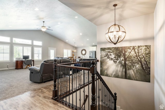 2402 W 525 S, Layton, UT 84041 - staircase featuring vaulted ceiling, wood finished floors, plenty of natural light, ceiling fan, and a chandelier