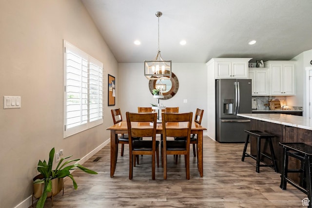2402 W 525 S, Layton, UT 84041 - dining space with a chandelier, wood finished floors, recessed lighting, and vaulted ceiling