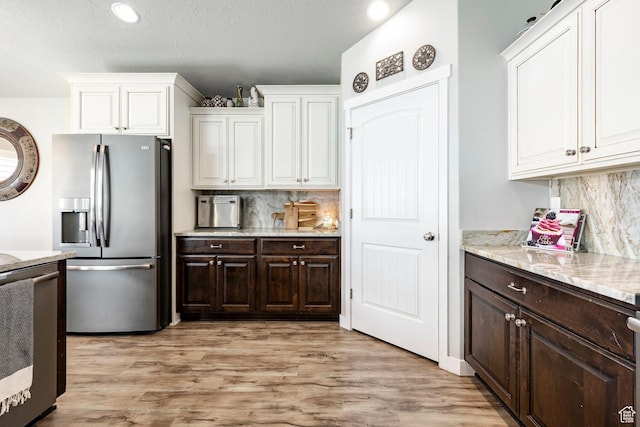 2402 W 525 S, Layton, UT 84041 - kitchen with stainless steel refrigerator with ice dispenser, range, white cabinetry, dark brown cabinetry, and recessed lighting