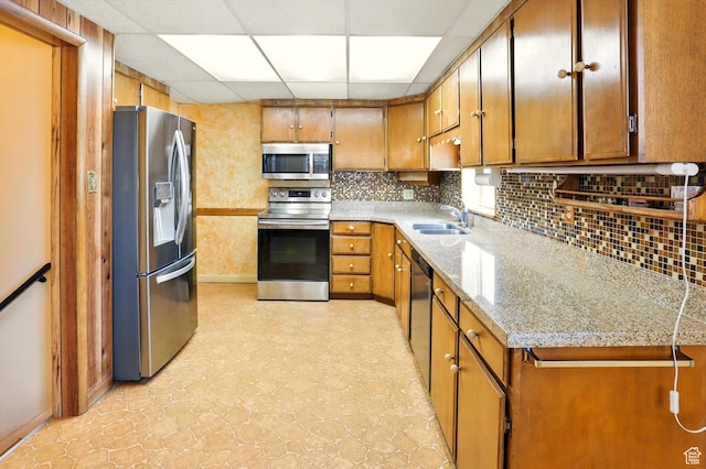 1743 N 250 W, Sunset, UT 84015 - kitchen with stainless steel appliances, a paneled ceiling, brown cabinets, and tasteful backsplash