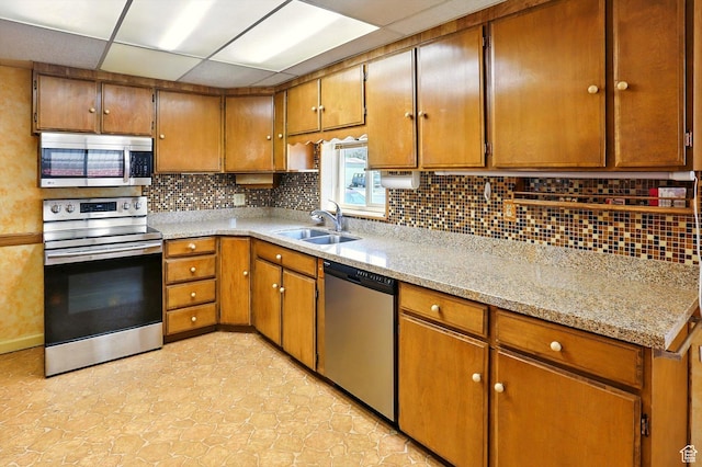 1743 N 250 W, Sunset, UT 84015 - kitchen with stainless steel appliances, decorative backsplash, brown cabinets, a drop ceiling, and light stone counters