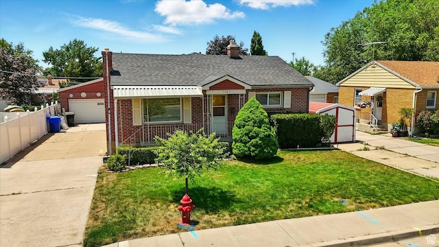 1743 N 250 W, Sunset, UT 84015 - bungalow-style home featuring brick siding, a chimney, a detached garage, and roof with shingles