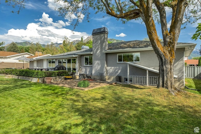 2241 E Melodie Ann Way, Holladay, UT 84124 - rear view of property featuring a patio, a chimney, brick siding, and a mountain view