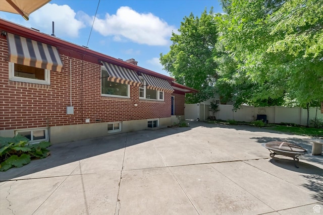 871 N 400 E, Logan, UT 84321 - view of home's exterior featuring brick siding and a patio area