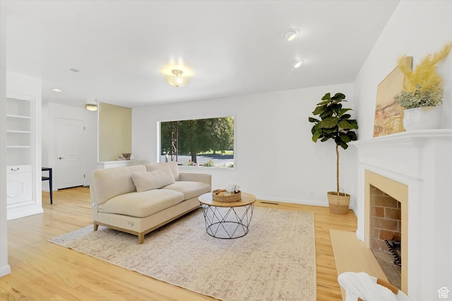 871 N 400 E, Logan, UT 84321 - living area featuring light wood-type flooring and a fireplace with flush hearth