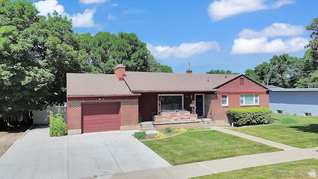 871 N 400 E, Logan, UT 84321 - single story home with an attached garage, brick siding, a chimney, concrete driveway, and a front lawn