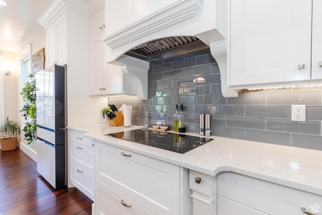981 E Pebble Creek Rd, Smithfield, UT 84335 - kitchen featuring black electric stovetop, custom range hood, freestanding refrigerator, and white cabinets