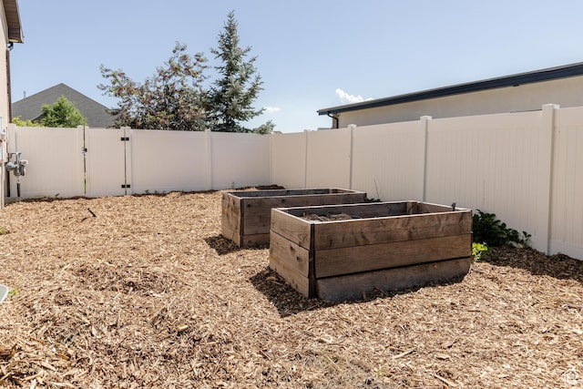 981 E Pebble Creek Rd, Smithfield, UT 84335 - fenced backyard featuring a gate and a vegetable garden