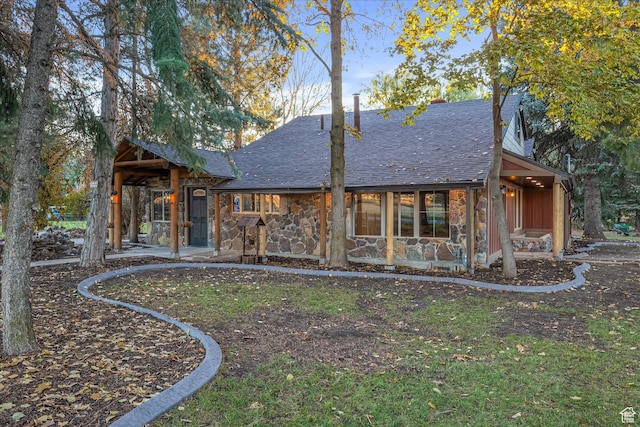 210 S 100 E, Fielding, UT 84311 - back of property featuring a patio area, stone siding, and roof with shingles