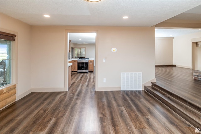 210 S 100 E, Fielding, UT 84311 - empty room with dark wood-style flooring, a textured ceiling, and recessed lighting