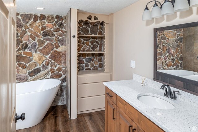 210 S 100 E, Fielding, UT 84311 - full bathroom with a freestanding tub, vanity, wood finished floors, and a textured ceiling