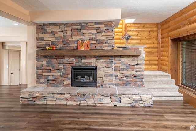 210 S 100 E, Fielding, UT 84311 - detailed view of log walls, a textured ceiling, wood finished floors, and a fireplace