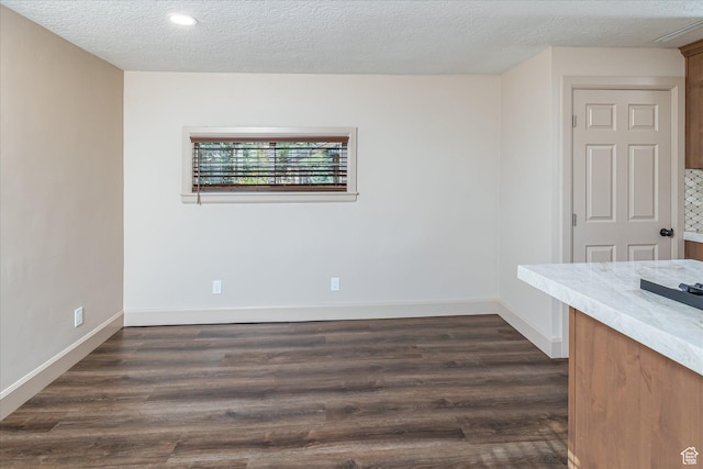 210 S 100 E, Fielding, UT 84311 - empty room featuring a textured ceiling, dark wood-type flooring, and recessed lighting