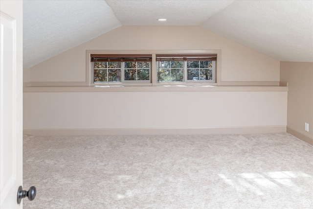 210 S 100 E, Fielding, UT 84311 - additional living space with a textured ceiling, carpet floors, lofted ceiling, and plenty of natural light