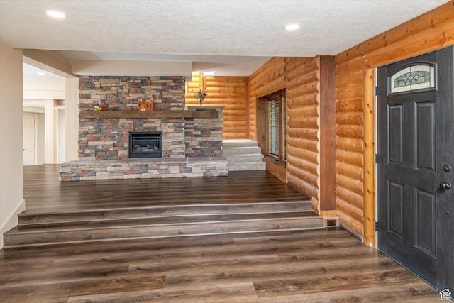 210 S 100 E, Fielding, UT 84311 - unfurnished living room with rustic walls, a textured ceiling, wood finished floors, a fireplace, and recessed lighting