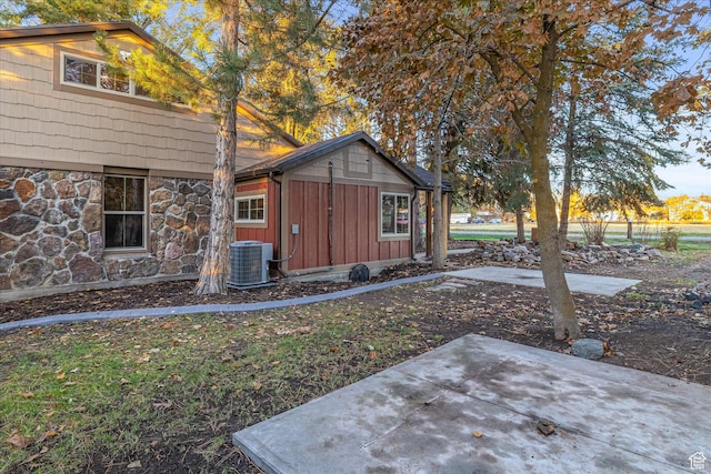 210 S 100 E, Fielding, UT 84311 - view of front of house with board and batten siding, a patio area, and stone siding