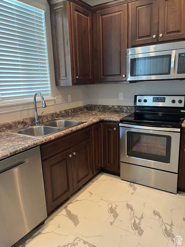 1268 W 320 N, Provo, UT 84601 - kitchen with appliances with stainless steel finishes, light marble finish flooring, dark countertops, and dark brown cabinetry