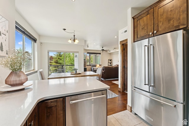 14275 N Buck Horn Trl Unit 41-F, Kamas, UT 84036 - kitchen featuring appliances with stainless steel finishes, a chandelier, light countertops, open floor plan, and recessed lighting