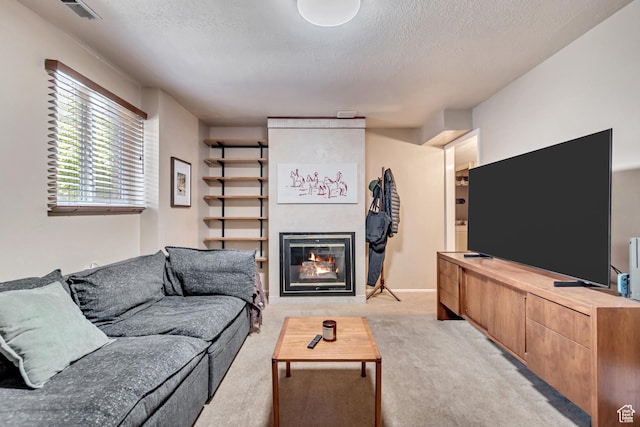 4797 S 2124 E, Holladay, UT 84117 - living area with light carpet, a tiled fireplace, and a textured ceiling
