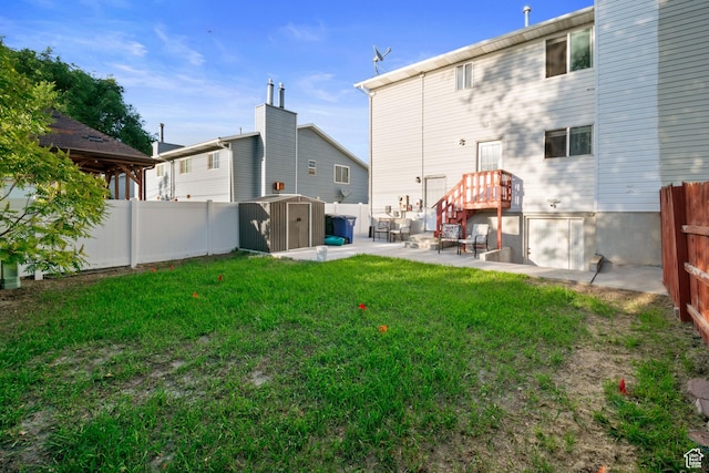 3638 Oldham Cir, West Valley City, UT 84120 - back of property featuring a storage unit, a patio area, and a fenced backyard