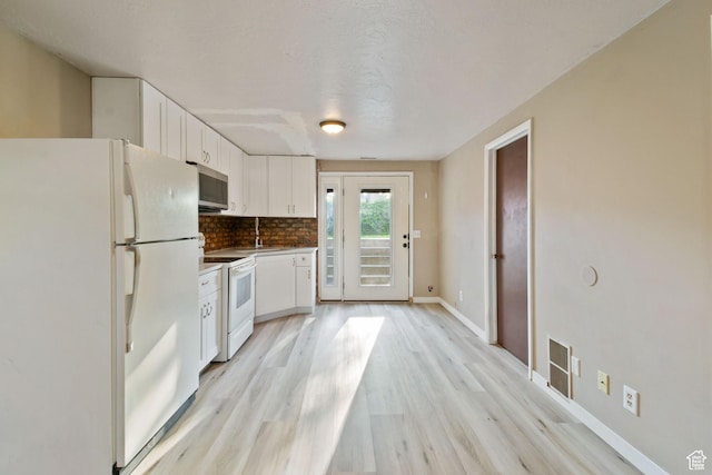 3638 Oldham Cir, West Valley City, UT 84120 - kitchen with white appliances, white cabinets, backsplash, and light wood finished floors
