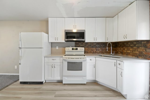 3638 Oldham Cir, West Valley City, UT 84120 - kitchen with white appliances, white cabinetry, light wood-type flooring, decorative backsplash, and light countertops
