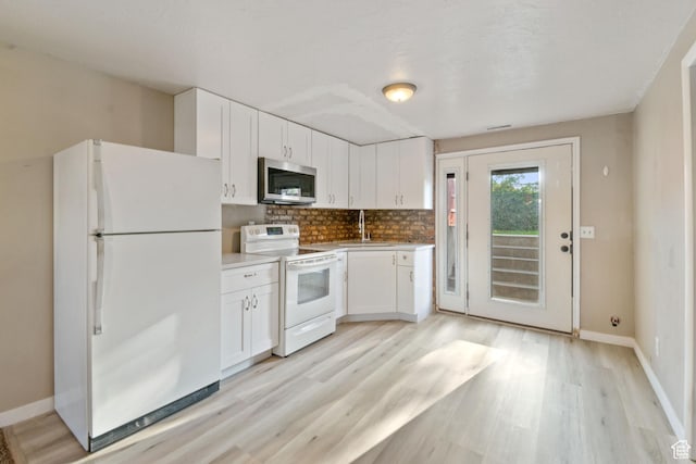 3638 Oldham Cir, West Valley City, UT 84120 - kitchen featuring white appliances, light wood-type flooring, and white cabinets