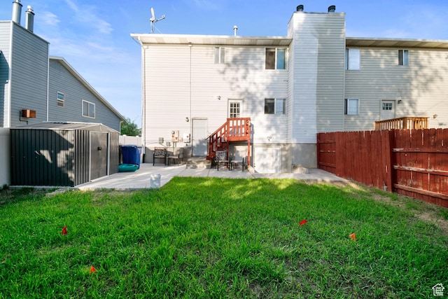 3638 Oldham Cir, West Valley City, UT 84120 - rear view of property with a patio, a fenced backyard, a storage shed, and a chimney