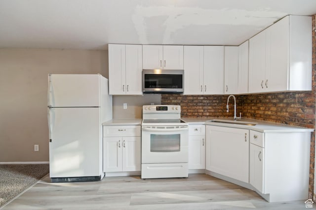 3638 Oldham Cir, West Valley City, UT 84120 - kitchen featuring white appliances, light wood-type flooring, white cabinets, and backsplash