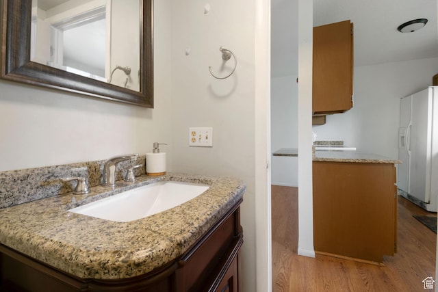 3638 Oldham Cir, West Valley City, UT 84120 - bathroom with wood finished floors and vanity