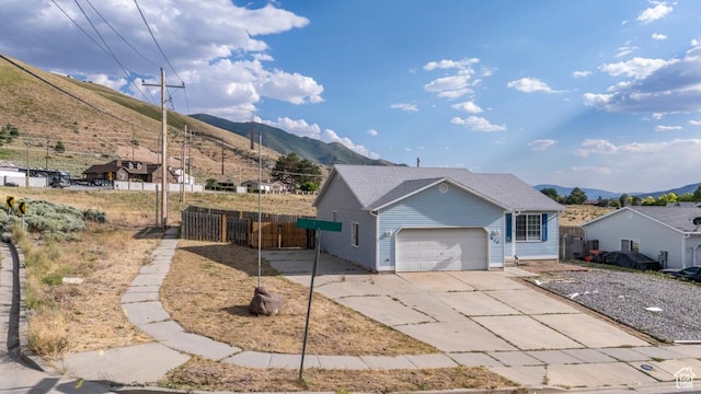 615 W 1080 S, Tooele, UT 84074 - view of front of house featuring a mountain view, a garage, and concrete driveway