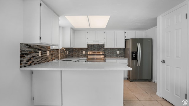 607 N 2000 W, West Point, UT 84015 - kitchen with appliances with stainless steel finishes, under cabinet range hood, light countertops, white cabinetry, and a peninsula