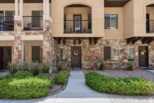 5538 N Turin Ln, Highland, UT 84003 - view of front of property featuring stone siding, a balcony, and stucco siding