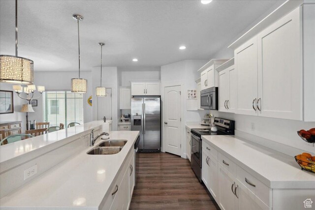 5538 N Turin Ln, Highland, UT 84003 - kitchen with appliances with stainless steel finishes, white cabinets, dark wood-style flooring, hanging light fixtures, and recessed lighting