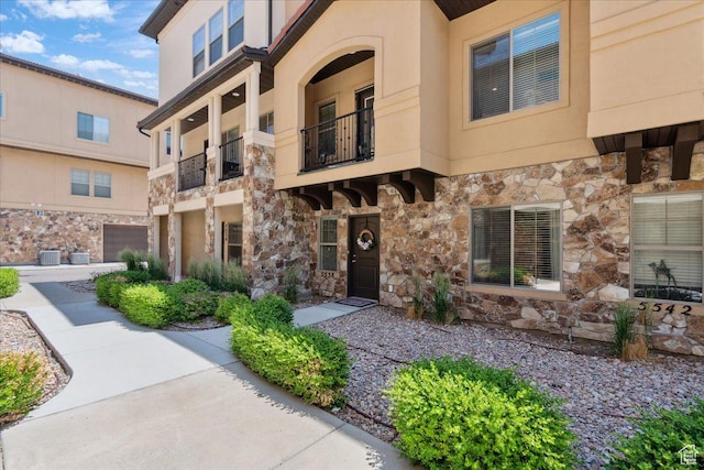 5538 N Turin Ln, Highland, UT 84003 - view of front of house featuring stone siding, stucco siding, and a balcony