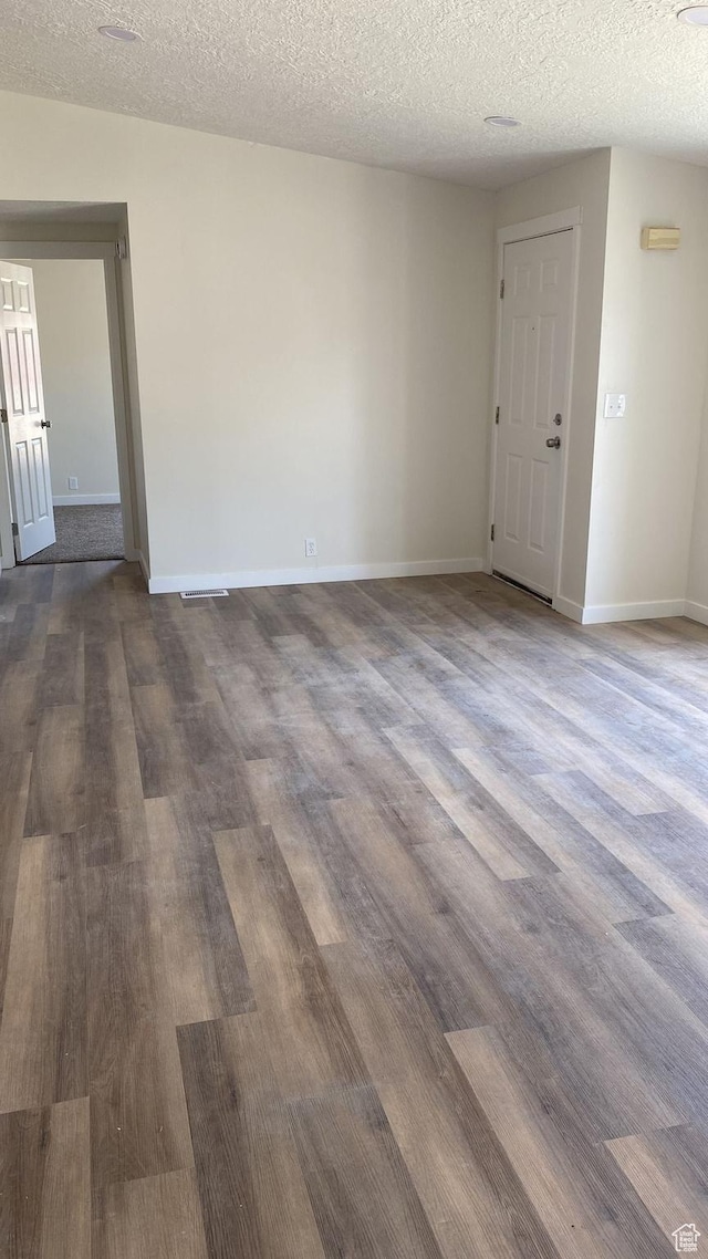 371 Broadmoor Ave, Ogden, UT 84404 - unfurnished room with a textured ceiling and dark wood-style flooring