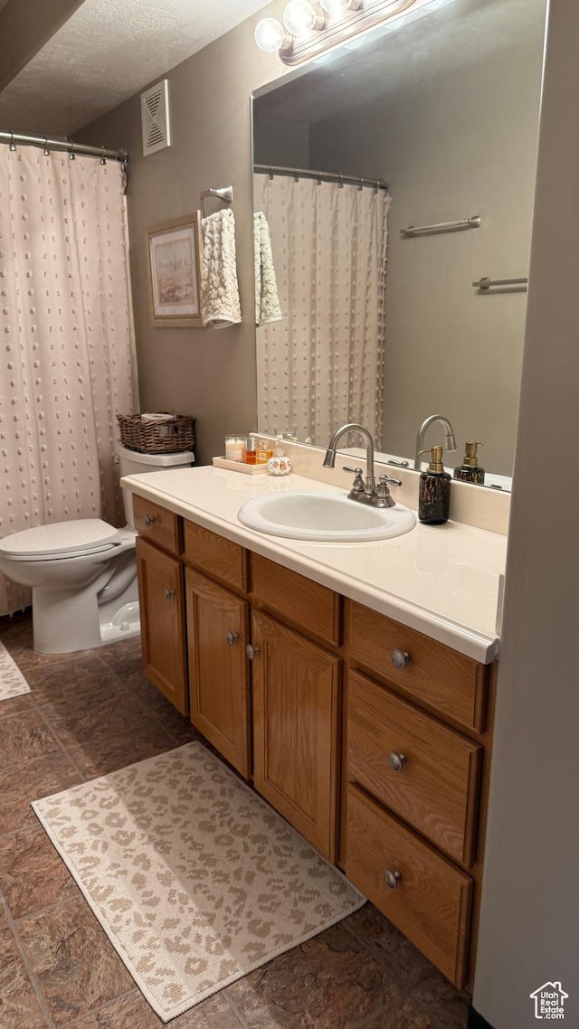 1205 E Privet Dr S Unit 101, Cottonwood Heights, UT 84121 - full bathroom featuring vanity, stone finish floors, and a textured ceiling