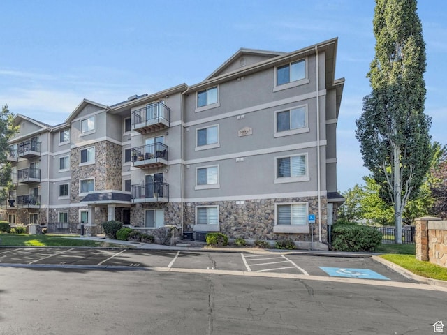 1205 E Privet Dr S Unit 101, Cottonwood Heights, UT 84121 - view of apartment building / complex with uncovered parking