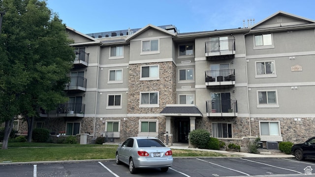 1205 E Privet Dr S Unit 101, Cottonwood Heights, UT 84121 - view of apartment building / complex with uncovered parking
