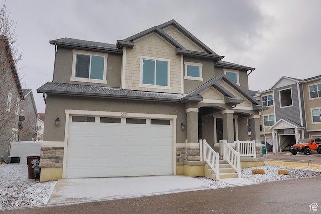 5001 W Anegada Ln S, Herriman, UT 84096 - craftsman house with stone siding, a garage, concrete driveway, stucco siding, and a porch