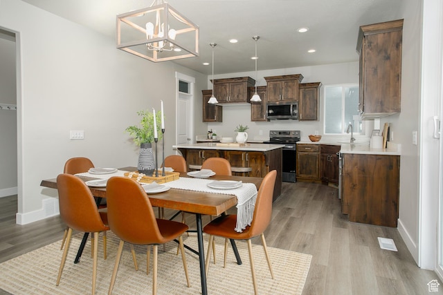 5001 W Anegada Ln S, Herriman, UT 84096 - dining room with light wood-style floors, recessed lighting, and a chandelier