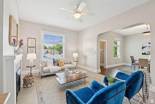 921 E 800 S, Salt Lake City, UT 84102 - living room with arched walkways, wood finished floors, a ceiling fan, and a fireplace