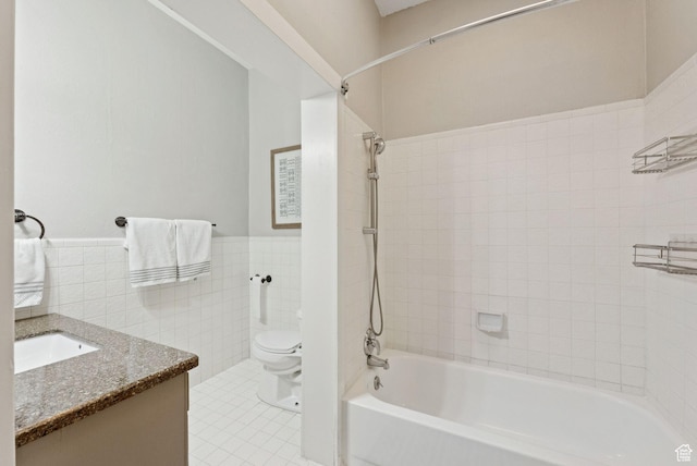 921 E 800 S, Salt Lake City, UT 84102 - full bath featuring tile walls, bathing tub / shower combination, vanity, a wainscoted wall, and tile patterned flooring