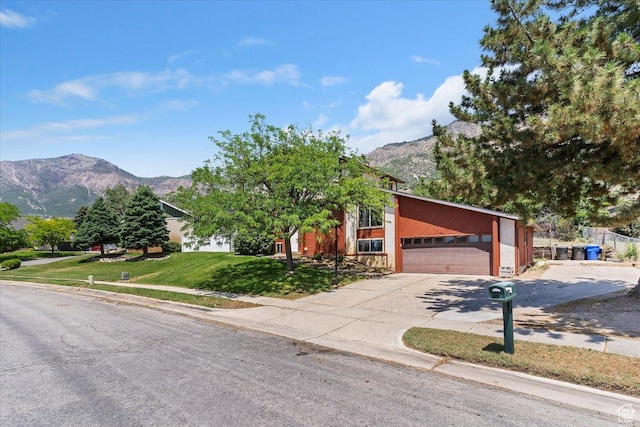 1260 E 2925 N, North Ogden, UT 84414 - view of front facade featuring a mountain view, concrete driveway, a garage, and a front yard