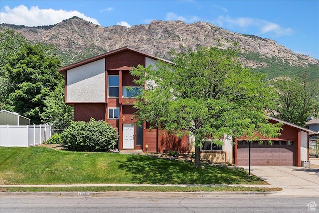 1260 E 2925 N, North Ogden, UT 84414 - mid-century modern home featuring concrete driveway, a mountain view, and a garage