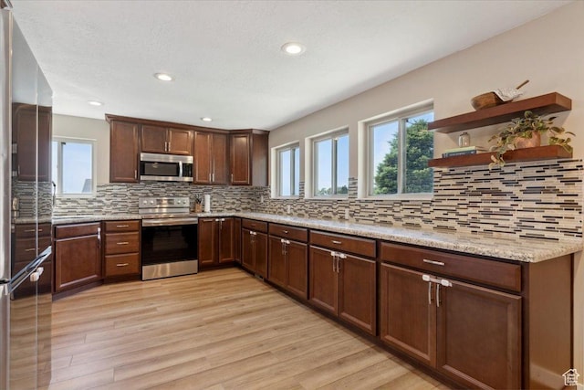 1260 E 2925 N, North Ogden, UT 84414 - kitchen featuring appliances with stainless steel finishes, light wood finished floors, decorative backsplash, open shelves, and recessed lighting