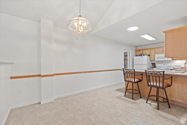 3304 S Hunter Villa Ln Unit D, West Valley City, UT 84128 - kitchen featuring white appliances, a chandelier, light brown cabinetry, light countertops, and a kitchen breakfast bar